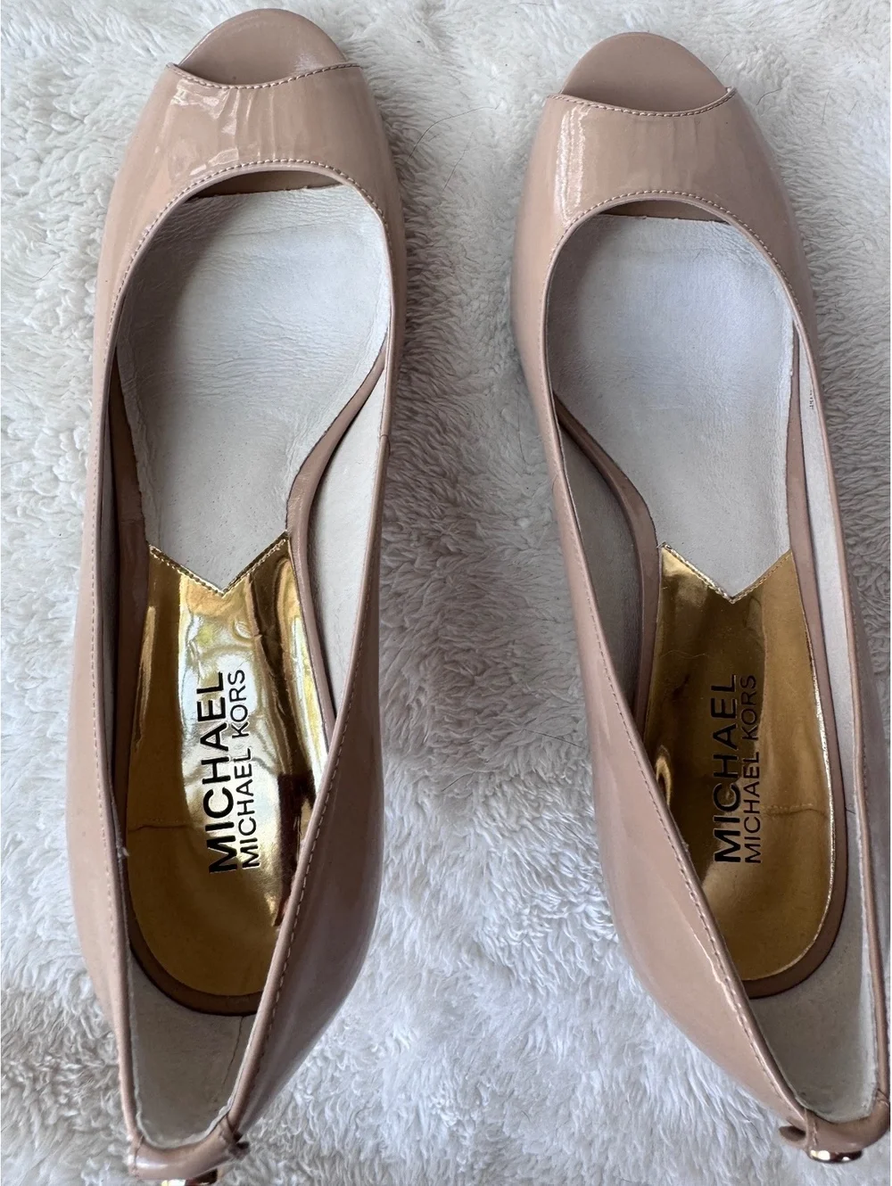 Michael Kors women’s patent leather peep-toe pumps in a classic nude/blush color